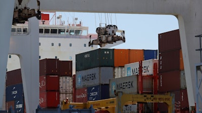 In this July 22, 2019 file photo, the container ship Kota Ekspres is unloaded at the Port of Oakland in Oakland, CA.