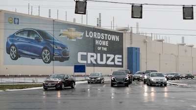 In this Nov. 27, 2018 file photo, a banner depicting the Chevrolet Cruze model vehicle is displayed at the General Motors' Lordstown plant in Lordstown, Ohio. An economic renaissance in the industrial Midwest promised by President Donald Trump has suffered in recent weeks in ways that could be problematic for Trump's 2020 re-election.