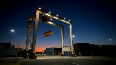 In this Jan. 30, 2018 file photo, a rubber tire gantry moves into position to transfer shipping containers at the Georgia Ports Authority's Port of Savannah in Savannah, GA.