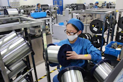 In this Aug. 14, 2019 file photo, a woman works on a production line in a fiber optics factory in Nantong in eastern China's Jiangsu province.