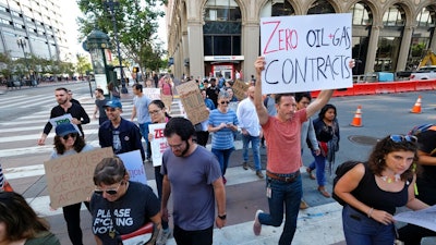 In this Friday, Sept. 20, 2019 file photo, Google employees make their way up Market Street to join others in a climate strike rally at City Hall, in San Francisco. Microsoft and other tech giants have been competing to strike lucrative partnerships with ExxonMobil, Chevron, Shell, BP and other energy firms. The deals have been met with internal opposition from environmentally-minded tech workers.