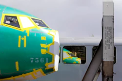 In this April 9, 2019, file photo the front of a Boeing 737 fuselage, eventually bound for Boeing's production facility in nearby Renton, Wash., sits on a flatcar rail car and is reflected in a nearby passenger train car at a rail yard in Seattle. Boeing said Tuesday, Oct. 8, that it delivered just 26 planes in September, down from 87 a year earlier, when it was ramping up Max production.