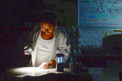 Carlos Lama of Bayside Cafe, which was among businesses to lose power due to PG&E's public safety power shutoff, uses an LED lamp and light from his phone at the counter of the restaurant in Sausalito, Calif., Wednesday, Oct. 9, 2019. More than a million people in California were without electricity Wednesday as the state's largest utility pulled the plug to prevent a repeat of the past two years when windblown power lines sparked deadly wildfires that destroyed thousands of homes.