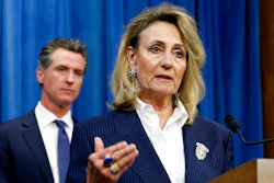 In this July 23, 2019, file photo, Marybel Batjer, of the California Public Utilities Commission, speaks during a news conference as Gov. Gavin Newsom looks on in Sacramento, Calif. California's utility regulator is issuing a series of sanctions against Pacific Gas and Electric for what it calls 'failures in execution' during the largest planned power shut-off in state history to avoid wildfires. Batjer said Monday, Oct. 14, 2019, the utility needs to have a goal of restoring power within 12 hours instead of its current 48 hours, minimize the scale of future outages and better communicate with the public and local officials.