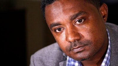 In this photo taken Monday, Sept. 23, 2019, Yonas Yeshanew, who resigned as Ethiopian Airline's chief engineer this summer and is seeking asylum in the U.S., listens to a reporter's question during an interview in Seattle area. Yeshanew says in a whistleblower complaint filed with regulators that the carrier went into the maintenance records on a Boeing 737 Max jet a day after it crashed this year, a breach he contends was part of a pattern of corruption that included fabricating documents, signing off on shoddy repairs and even beating those who got out of line.