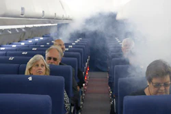 FAA employees participate in a demonstration of an airline cabin filling with smoke, in a simulator at the FAA Civil Aerospace Medical Institute in the Mike Monroney Aeronautical Center, Thursday, Oct. 17, 2019, in Oklahoma City. Federal researchers, using 720 volunteers in Oklahoma City, will test whether smaller seats and crowded rows slow down airline emergency evacuations.