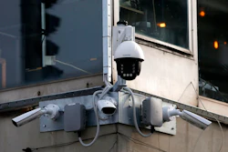 In this photo taken Sept. 25, 2019, high-tech video cameras hang from an office building in downtown Belgrade, Serbia. The cameras, equipped with facial recognition technology, are being rolled out across hundreds of cities around the world, particularly in poorer countries with weak track records on human rights where Beijing has increased its influence through big business deals.