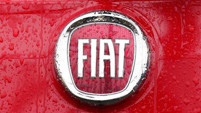In this Jan. 2, 2014 file photo, a Fiat logo pictured on a car in Milan, Italy. Italian-American carmaker Fiat Chrysler Automobiles on Wednesday, Oct. 30, 2019 confirmed that it is in talks with French rival PSA Peugeot, its second bid this year to reshape the global auto industry facing huge challenges with the transition to electric and autonomous vehicles.