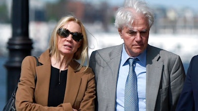 In this May 22, 2019 file photo, Marcia, left, and Gregory Abbott leave federal court after they pleaded guilty to charges in a nationwide college admissions bribery scandal. They are scheduled to be sentenced on Tuesday, Oct. 8.
