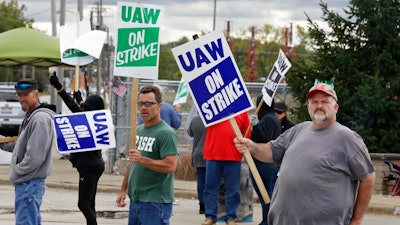 John Kirk, right, a 20-year-employee, pickets with co-workers outside the General Motors Fabrication Division, Friday, Oct. 4, 2019, in Parma, Ohio.