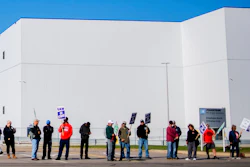 General Motors' Flint Assembly Plant employees line the street with picket signs during the nationwide UAW strike against General Motors on Monday, Oct. 7, 2019, in Flint, Mich.