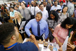 In this Sept. 17, 2019, file photo job seeker Cedric Edwards, center, shakes hands with recruiter Allen Lewis, left, during an Amazon job fair in Dallas. On Wednesday, Oct. 2, payroll processor ADP reports how many jobs private employers added in September.