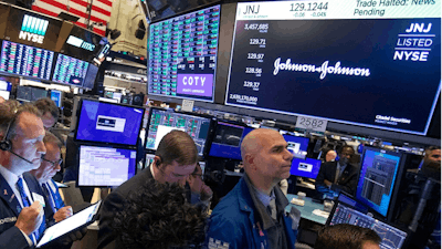 Traders gather at the post that handles Johnson & Johnson on the floor of the New York Stock Exchange, when trading was halted before the close, Tuesday, Oct. 29, 2019. Johnson & Johnson said Tuesday that new testing of a batch of baby powder that was recently recalled did not show any traces of asbestos. Earlier this month the company recalled 33,000 bottles of its talc powder after Food and Drug Administration testing revealed trace amounts of the dangerous substance in a single bottle.