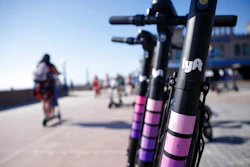 In this May 28, 2019, file photo Lyft scooters are seen along Mission Beach boardwalk in San Diego. Lyft, Inc. reports financial earns on Wednesday, Oct. 30.