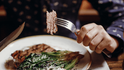 Man Eating Steak