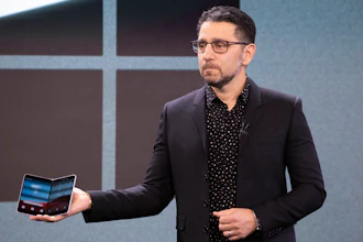 Microsoft's Chief Product Officer Panos Panay holds a Surface Duo.