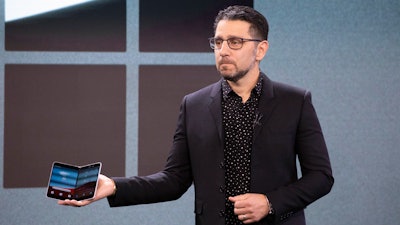 Microsoft's Chief Product Officer Panos Panay holds a Surface Duo.