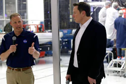 NASA Administrator Jim Bridenstine, left, talks with SpaceX chief engineer Elon Musk, right, in front of the Crew Dragon spacecraft, about the progress to fly astronauts to and from the International Space Station, from American soil, as part of the agency's commercial crew program at SpaceX headquarters, in Hawthorne, Calif., Thursday, Oct. 10, 2019.