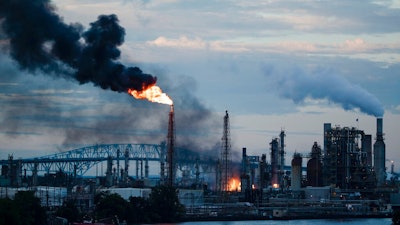 In this June 21, 2019 file photo, flames and smoke emerge from the Philadelphia Energy Solutions Refining Complex in Philadelphia. Federal investigators say an aging, failed elbow pipe appears to be the cause of the June fire and subsequent explosions that left five people with minor injuries and destroyed part of the processing unit at the largest oil refinery on the East Coast. The U.S. Chemical Safety and Hazard Investigation Board released a preliminary report Wednesday, Oct. 16 on findings from the June 21 explosion at the Philadelphia Energy Solutions Refining Complex.