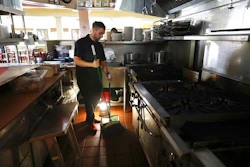 In this Oct. 10, 2019, file photo, Salvador Espinosa sweeps in the kitchen of a Mary's Pizza Shack restaurant during a Pacific Gas and Electric Co. power shutdown in Santa Rosa, Calif. The California Senate will investigate a California utility's process for cutting off power to more than 2 million people to prevent wildfires. In a memo to the Senate Democratic Caucus on Thursday, Oct. 17, 2019, Senate President Pro Tempore Toni Atkins asked the Senate Energy, Utilities, and Communications Committee to 'begin investigating and reviewing options to address the serious deficiencies' with PG&E's current process of shutting off power to prevent wildfires.