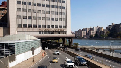 In this Sept. 26, 2019, photo, cars pass Rockefeller University in New York. Prestigious universities around the world, including Rockefeller, have accepted at least $60 million over the past five years from the family that owns the maker of OxyContin, even as the company became embroiled in lawsuits related to the opioid epidemic, financial records show. Rockefeller accepted more money from the Sacklers than any other school in recent history.