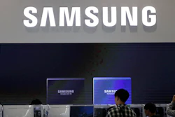Visitors tour near the logo of Samsung Electronics at semiconductor exhibition in Seoul, South Korea, Tuesday, Oct. 8, 2019. Samsung Electronics has predicted its operating profit for the last quarter will fall by more than 56% from a year earlier amid sluggish global demand for computer chips.