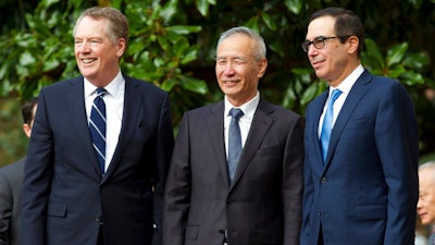 Chinese Vice Premier Liu He accompanied by U.S. Trade Representative Robert Lighthizer, left, and Treasury Secretary Steven Mnuchin, greets the media before a minister-level trade meetings at the Office of the United States Trade Representative in Washington, Thursday, Oct. 10, 2019.