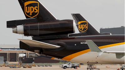 In this file photo a UPS aircraft taxis to its hangar area. UPS says it won government approval to run a drone airline, and it plans to expand deliveries.