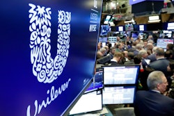 In this Thursday, March 15, 2018 file photo, the logo for Unilever appears above a trading post on the floor of the New York Stock Exchange. Consumer products giant Unilever, whose brands include Dove soaps and Lipton teas, said on Monday Oct. 7, 2019, they are pledging to halve its use of non-recycled plastics by 2025.