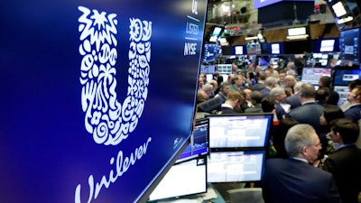 In this Thursday, March 15, 2018 file photo, the logo for Unilever appears above a trading post on the floor of the New York Stock Exchange. Consumer products giant Unilever, whose brands include Dove soaps and Lipton teas, said on Monday Oct. 7, 2019, they are pledging to halve its use of non-recycled plastics by 2025.