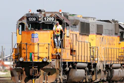 In this July 20, 2017, file photo, a Union Pacific Railroad Company employee stands on a locomotive in Council Bluffs, Iowa. More than two dozen major companies ranging from Campbell Soup to Kia filed anti-trust lawsuits on Sept. 30, 2019 against the nation's four largest railway companies, contending the railroads had a price-fixing scheme to illegally boost profits.