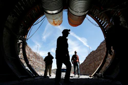 In this April 9, 2015, file photo, people walk into the south portal of Yucca Mountain during a congressional tour of the proposed radioactive waste dump near Mercury, Nev., 90 miles northwest of Las Vegas. A federal judge in Reno has agreed to allow Nevada to amend its lawsuit in an ongoing legal battle with the U.S. Energy Department to try to show why the government should be forced to remove weapons-grade plutonium it secretly shipped to a site near Las Vegas last year over the state's objections.