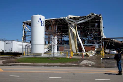 Debris can be seen as emergency personnel and others search and clear the scene of an explosion and fire at AB Specialty Silicones chemical plant May 4, 2019, in Waukegan, IL.