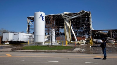 Debris can be seen as emergency personnel and others search and clear the scene of an explosion and fire at AB Specialty Silicones chemical plant May 4, 2019, in Waukegan, IL.