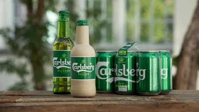 In this undated handout photo provided by Carlsberg, the new paper bottle is seen in Denmark. Danish brewer Carlsberg says it is developing a paper beer bottle made from sustainably sourced wood fibers. The Copenhagen-based company unveiled Friday, Oct. 11, 2019 two new prototypes that are 'fully recyclable and have an inner barrier to allow the bottles to contain beer.'