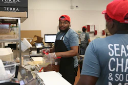 Workers in the B.Good ghost kitchen inside Kitchen United's Chicago location prepare food for delivery.