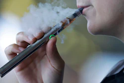 In this Friday, Oct. 4, 2019, file photo, a woman using an electronic cigarette exhales in Mayfield Heights, Ohio. A Michigan judge is blocking the state's two-week-old ban on flavored e-cigarettes. Court of Claims Judge Cynthia Stephens issued a preliminary injunction Tuesday, Oct. 15, 2019. She says Michigan Gov. Gretchen Whitmer's administration's delay in implementing the ban undercut its position that emergency rules were needed.