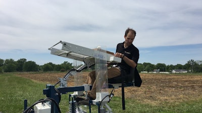 Professor Tim Beissinger on a tractor during the planting phase of the experiment.