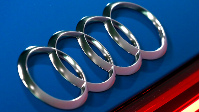 In this file photo dated Thursday, March 14, 2019, the logo of the German car manufacturer Audi is pictured on a Audi e-tron prior to the annual press conference in Ingolstadt, Germany. The Ingolstadt-based automaker said Tuesday Nov. 26, 2019, that it expected to add 2,000 new positions while Volkswagen subsidiary Audi says it is cutting 9,500 jobs in Germany through 2025.
