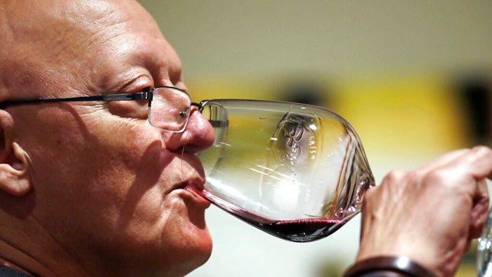In this photo taken Thursday, Nov. 21, 2019, Ben Norton sips a red wine during a tasting at Chateau Ste. Michelle winery in Woodinville, Wash. Washington, which now boasts more than 1,000 wineries in the state, has become a force in the wine industry. The state is the second-largest producer of premium wines in the United States, trailing only California.