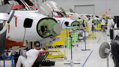 In this July 30, 2019, file photo people work in the production area at the Honda Aircraft Co. headquarters in Greensboro, NC where the HondaJet Elite aircraft is manufactured.