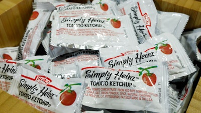 In this Aug. 8, 2019 file photo, packets of Simply Heinz ketchup fill a cafeteria condiment box in New York.