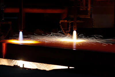 In this June 28, 2018 file photo, a hot slab of steel is cut into sections after exiting the caster inside the U.S. Steel Granite City Works facility in Granite City, IL.