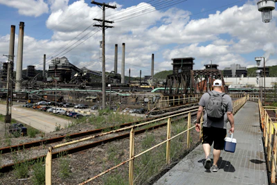 In this May 2, 2019 file photo, a worker arrives for his shift at the U.S. Steel Clairton Coke Works in Clairton, PA.