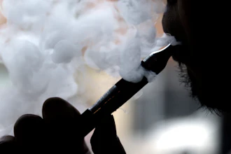 In this April 23, 2014 file photo, a man smokes an electronic cigarette in Chicago.