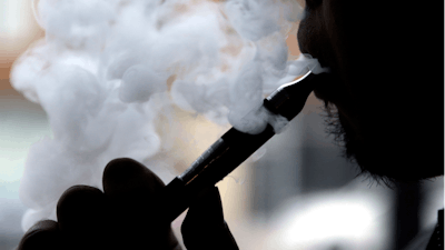 In this April 23, 2014 file photo, a man smokes an electronic cigarette in Chicago.