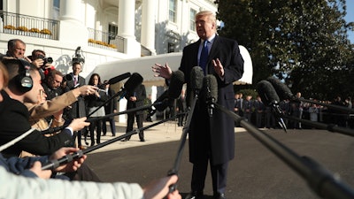 President Donald Trump speaks to reporters on the South Lawn of the White House in Washington on Friday before boarding Marine One for a short trip to Andrews Air Force Base, Md. and then on to Georgia to meet with supporters.