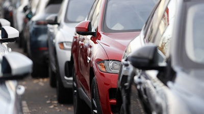 In this Nov. 10, 2019 photo, a long row of unsold 2020 F-Pace sports-utility vehicles sits at a Jaguar dealership in Littleton, CO.