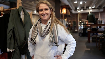 In this Thursday, Nov. 14 photo, Annie Venditti, vice president of operations at clothing retailer American Rhino, stands for a photograph in the store, in Faneuil Hall Marketplace, in Boston. At the age of 23, Venditti was learning about the complexities of building and liquor laws. The company did the smart thing, and got a consultant to guide them.