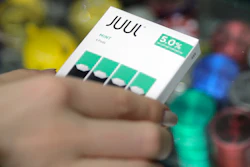 In this Dec. 20, 2018, file photo a woman buys refills for her Juul at a smoke shop in New York.